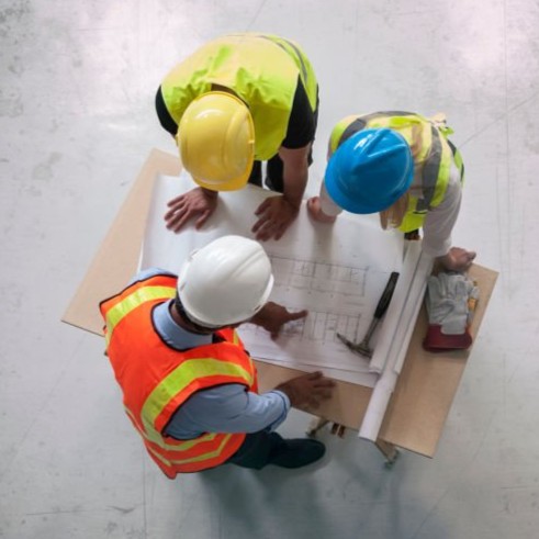 Engineers looking at blueprints